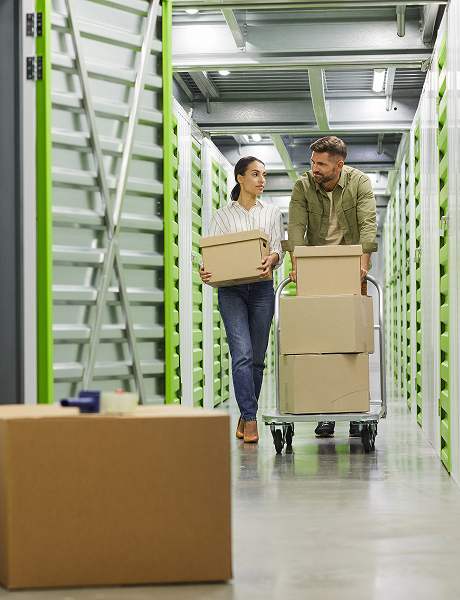 2 people loading boxes into storage